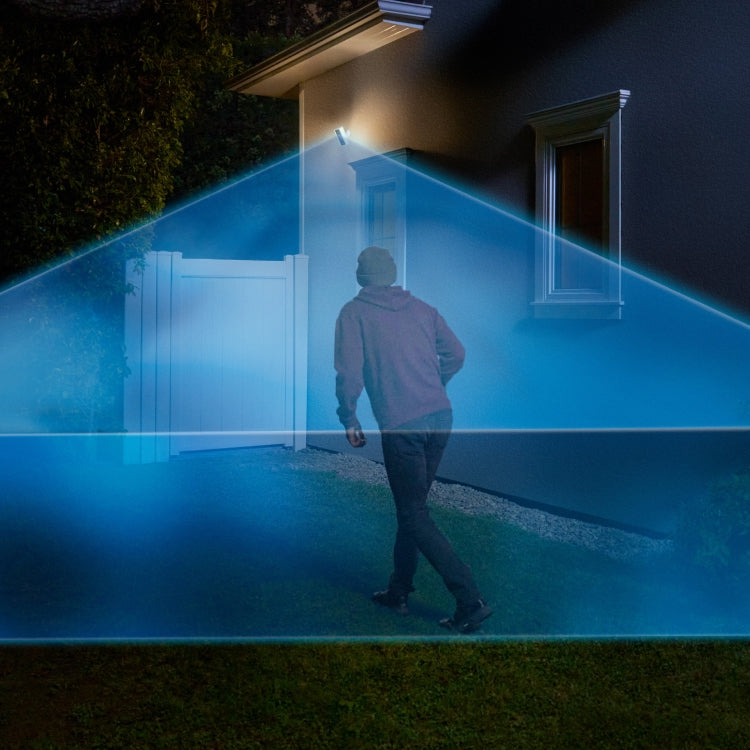 Suspicious person walks into the side garden of a home at night. They're covered in a blue laser graphic extending out from a Ring Spotlight Cam Pro (newest gen) mounted to the house.